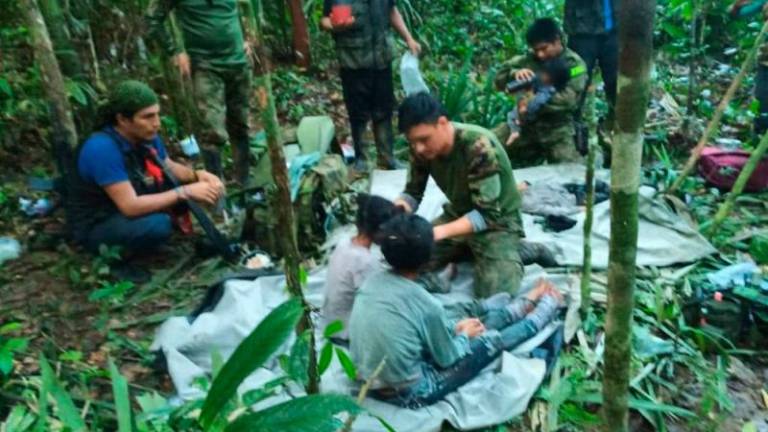 Colombian Presidency, members of the army assist four indigenous children who were found alive after spending more than a month lost in the Colombian Amazon jungle following the crash of a small plane//AFPix