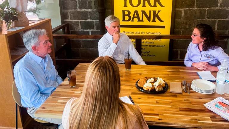 Powell (left) and Philadelphia Fed president Patrick Harker sit down with Julie Keene, an owner and operator of Flinchbaugh's Orchard &amp; Farm Market, during a walking tour of York, Pennsylvania, on Monday. – Reuterspic