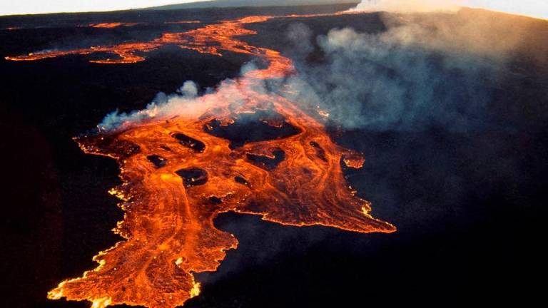 This aerial image released by the US Geological Survey (USGS) on November 28, 2022 courtesy of the National Weather Service, shows the lava in the summit caldera of Mauna Loa in Hawaii, which is erupting for the first time in nearly 40 years. AFPPIX