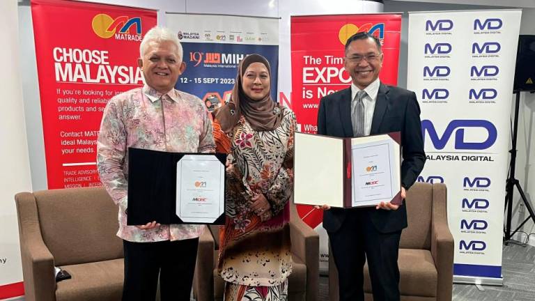 From left: Mohd Mustafa, Matrade senior board member Datuk Hazimah Zainuddin and Mahadhir during the signing ceremony.