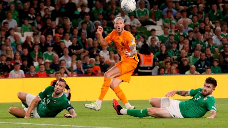 Adam Idah (L) and Ryan Manning (R) watch Wout Weghorst crosses the ball during the UEFA Euro 2024 group B qualification football match between Republic of Ireland and Netherlands at Aviva Stadium in Dublin, Ireland on September 10, 2023. AFPPIX