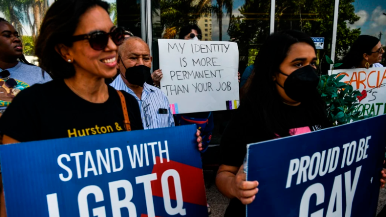 People hold placards as they protest outside the office of Florida State Senator Ileana Garcia in Coral Gables, Florida earlier this year. AFPPIX
