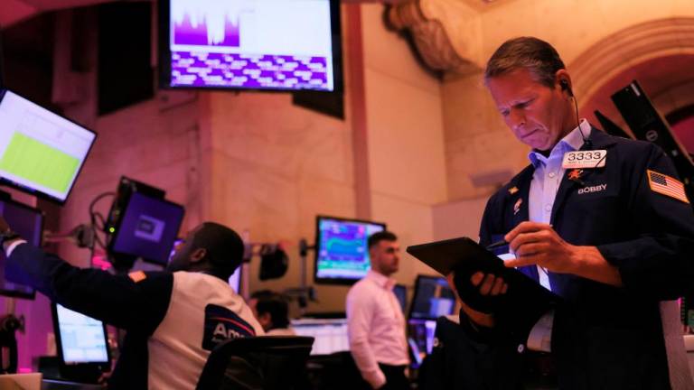 Traders on the floor of the New York Stock Exchange. US stocks closed lower but investors also sought bargains in a market that appears oversold. – AFPpix