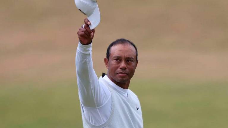Golf - The 150th Open Championship - Old Course, St Andrews, Scotland, Britain - July 15, 2022 Tiger Woods of the U.S. acknowledges the fans after holing on the 18th and finishing his second round REUTERSPIX