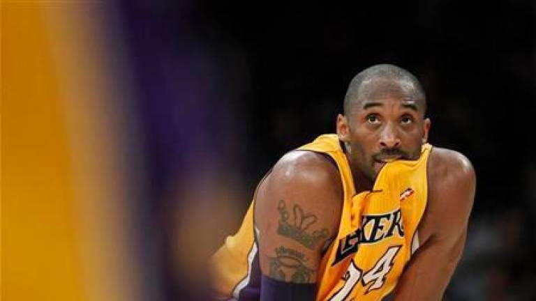 Los Angeles Lakers’ Kobe Bryant looks on against the New York Knicks during second half of an NBA game in Los Angeles December 29, 2011. REUTERSPIX