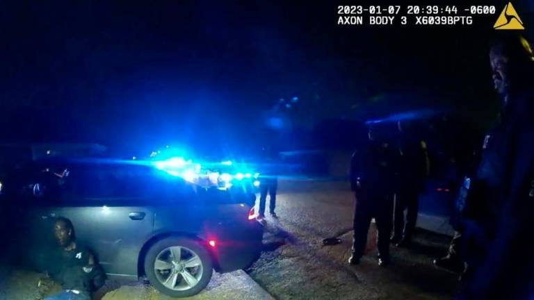 This still image from a Memphis Police Department body-cam video released by the city of Memphis on January 27, 2023, shows Tyre Nichols handcuffed on the ground surrounded by police officers, in Memphis, Tennessee. AFPPIX