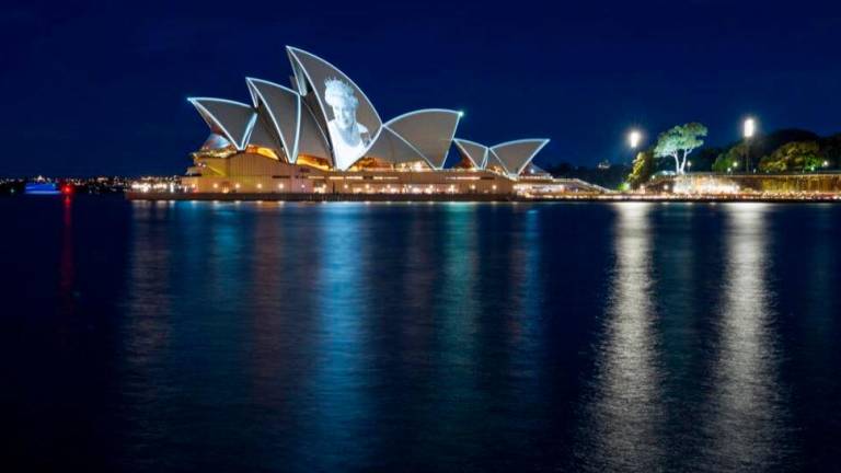 The sails of the architectural masterpiece on Sydney Harbour are illuminated in colours for important occasions, such as the death of Queen Elizabeth II in 2022. AFPPIX