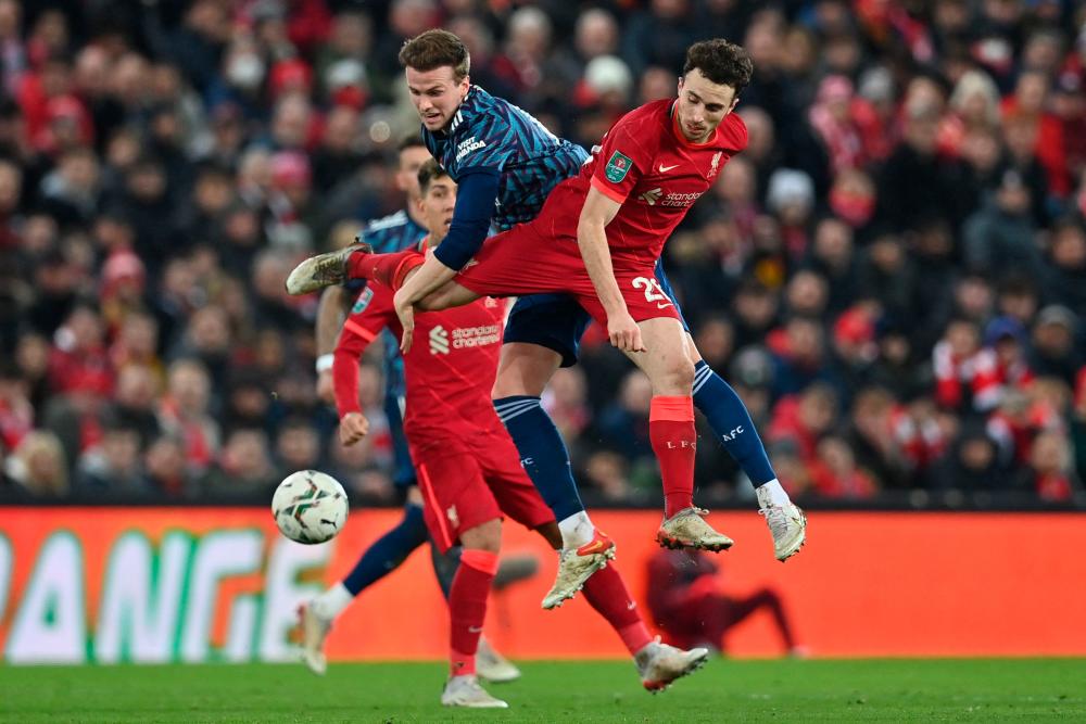 Arsenal's English defender Rob Holding (L) vies with Liverpool's Portuguese striker Diogo Jota (R) during the English League Cup semi-final first leg football match between Liverpool and Arsenal at Anfield in Liverpool/AFPPix