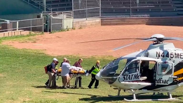In this frame grab from a video courtesy of Horatio Gates recorded on August 12, 2022, Salman Rushdie is seen being loaded onto a medical evacuation helicopter near the Chautauqua Institution after being stabbed in the neck while speaking on stage in Chautauqua, New York. AFPPIX