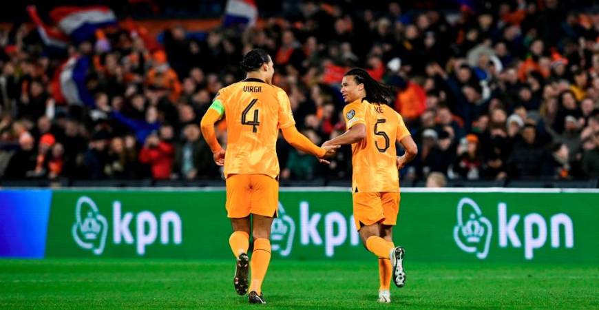 Nathan Ake (R) celebrates after scoring his team's third goal with Virgil van Dijk during the UEFA Euro 2024 group B qualification football match between Netherlands and Gibraltar at the Stadion Feijenoord 'De Kuip', in Rotterdam, on March 27, 2023. AFPPIX