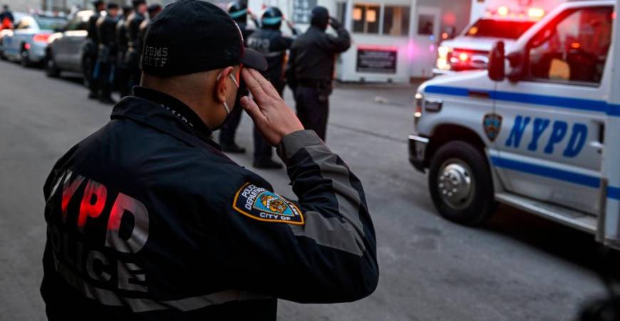 NEW YORK, NEW YORK - JANUARY 25: NYPD officers line up and salute as the body of Officer Wilbert Mora is transferred in an ambulance from NYU Langone Hospital to a Medical Examiner’s office at the same location on January 25, 2022 in New York City. AFPPIX