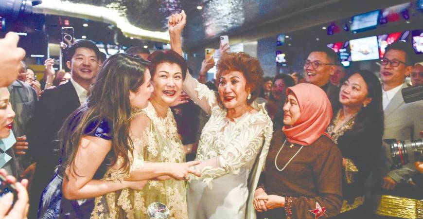 Datin Janet Yeoh (third from left) celebrating with well-wishers after daughter Michelle’s win. – AFP