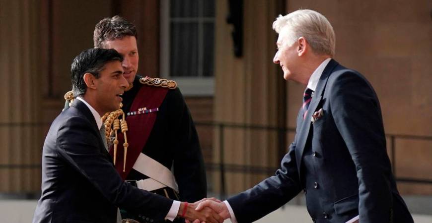 New Conservative Party leader and incoming prime minister Rishi Sunak (L) is greeted as he arrives at Buckingham Palace in London on October 25, 2022, for an audience with King Charles III, where he will be invited to form a government. AFPPIX