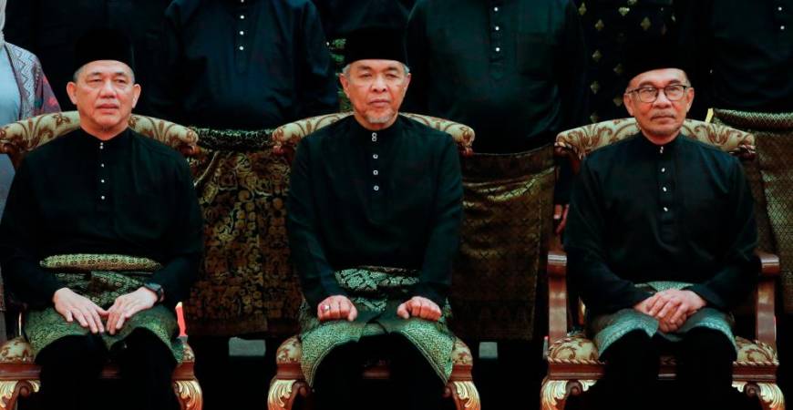 Prime Minister Anwar Ibrahim (R) poses with Deputy Prime Ministers Datuk Seri Ahmad Zahid Hamidi (C) and Datuk Seri Fadillah Yusof (L) after the swearing-in ceremony of the newly appointed cabinet ministers at the Istana Negara in Kuala Lumpur, on December 3, 2022. AFPPIX