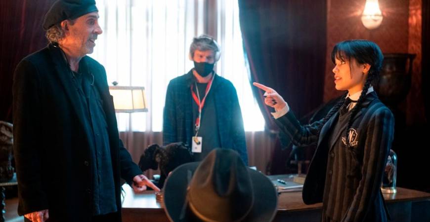 Jenna Ortega (right) and director Tim Burton on the set of ‘Wednesday’. – Netflix