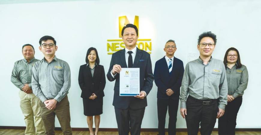 Lim (centre) with Nestcon finance director Lim Joo Seng (third from left), M&amp;A Securities head of corporate finance Gary Ting (third from right), and Nestcon’s key senior management team. Picture was taken before the implementation of the full MCO.