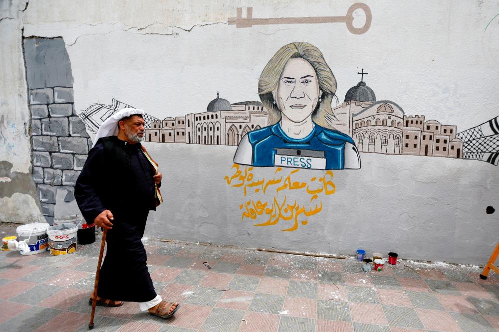 A man walks past a mural of Al Jazeera reporter Shireen Abu Akleh, killed during an Israeli raid in the Israeli-occupied West Bank, in Khan Younis in the southern Gaza. - REUTERSpix