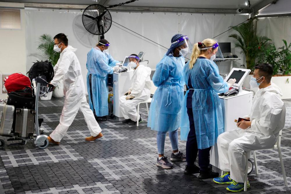 Travellers receive tests for the coronavirus disease (COVID-19) at a pre-departure testing facility, as countries react to the new coronavirus Omicron variant, outside the international terminal at Sydney Airport in Sydney, Australia, November 29, 2021. REUTERSPix