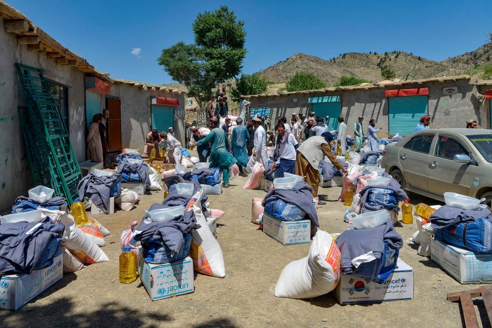 In this picture taken on June 24, 2022, volunteers prepare to distribute relief materials for the earthquake victims in Gayan district, Paktika province/AFPPix