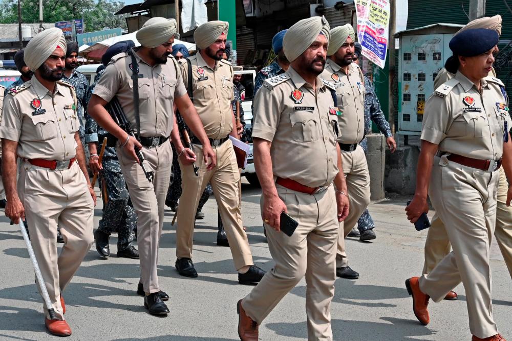 Punjab Police personnel patrol in the village Jallupur Khera about 45 km from Amritsar on March 19, 2023. - AFPPIX