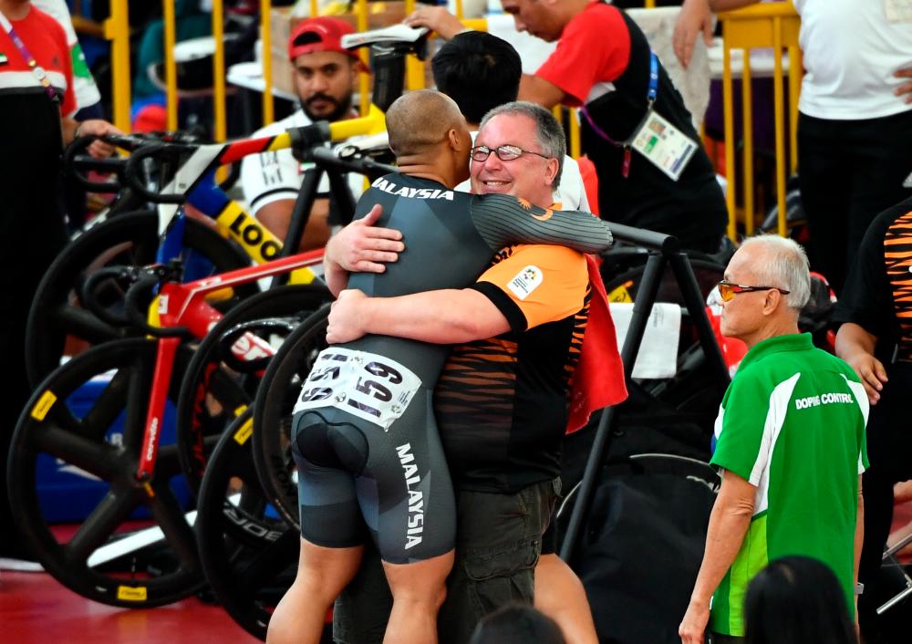 Azizulhasni Awang hugging coach John Beasley after winning the Men’s Sprint finals at the Asian Games in 2018 - Bernama