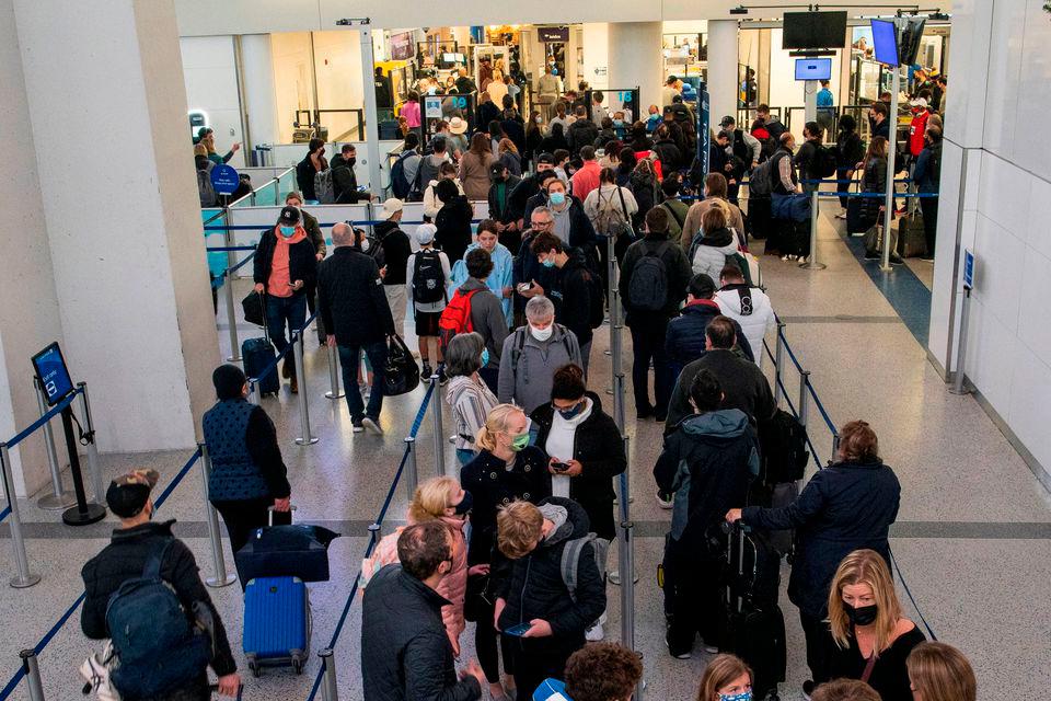 Passengers wait in line inside the terminal at Newark Liberty International Airport in Newark, New Jersey, U.S., November 24, 2021. REUTERSpix