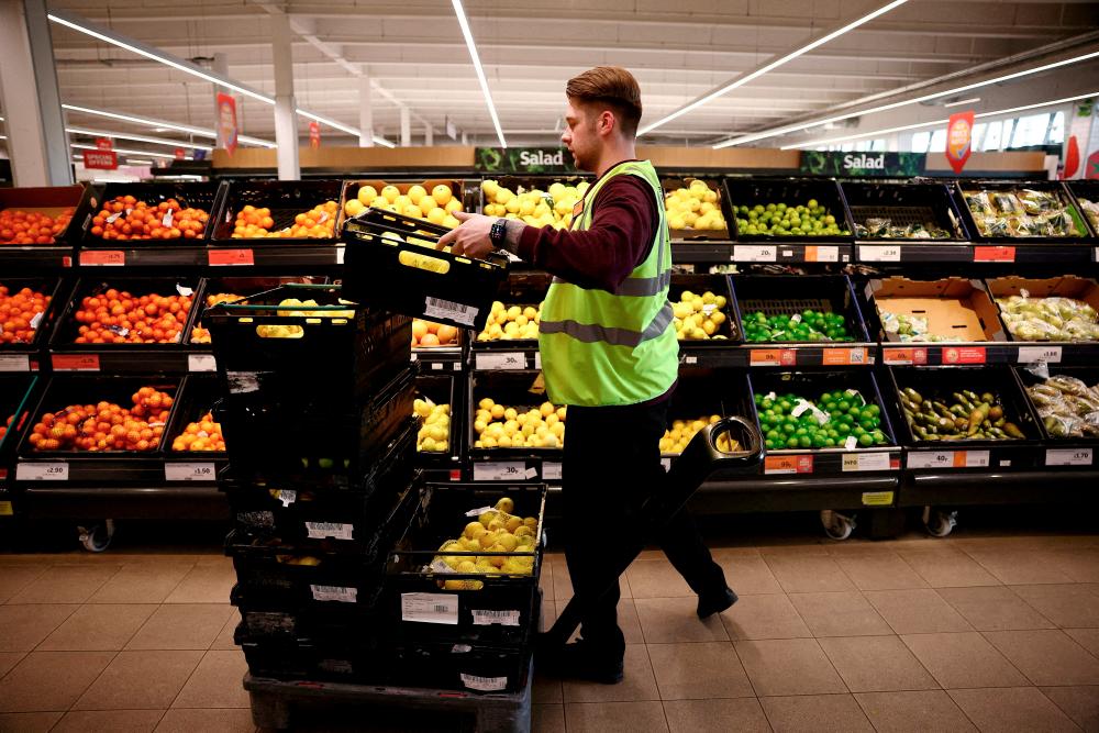An employee arranges produce inside a supermarket in Richmond, west London, Consumers are buckling under the pressure of the UK’s growing cost-of-living crisis driven by rapidly rising food prices, domestic fuel bills and mortgage payments, says GfK’s client strategy director. – Reuterspix