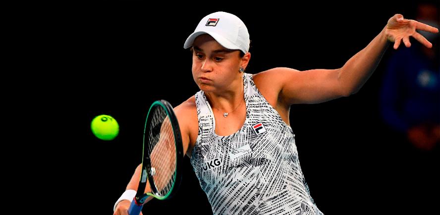 Australia’s Ashleigh Barty hits a return against Amanda Anisimova of the US during their women’s singles match on day seven of the Australian Open in Melbourne on Jan 23, 2022. – AFPPIX