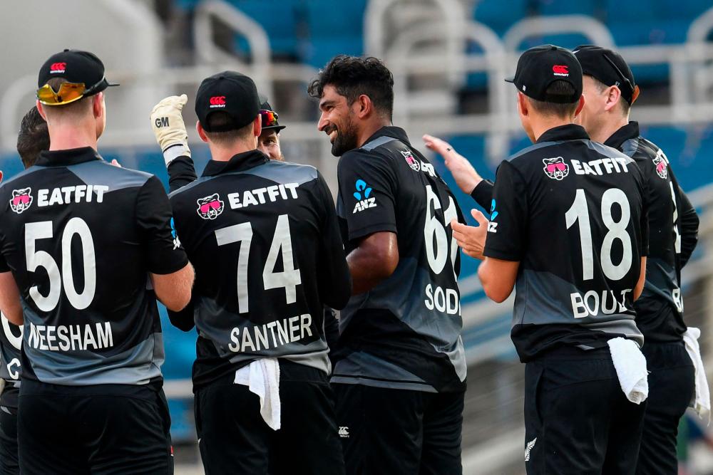 Ish Sodhi (2R) of New Zealand smiles after Rovman Powell of West Indies was dismissed during the 2nd T20i match between West Indies and New Zealand at Sabina Park, Kingston, Jamaica, on August 12, 2022. - AFPPIX
