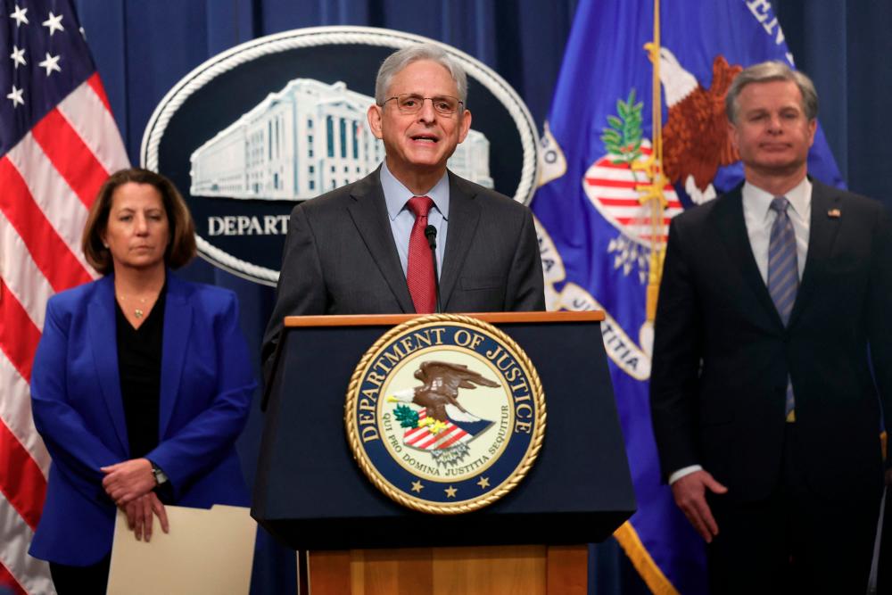 US Attorney General Merrick Garland (C), joined by Assistant Attorney General Lisa Monaco and Director of the Federal Bureau of Investigation (FBI) Christopher Wray, delivers remarks on an international ransomware enforcement action at the U.S. Justice Department on January 26, 2023 in Washington, DC. AFPPIX