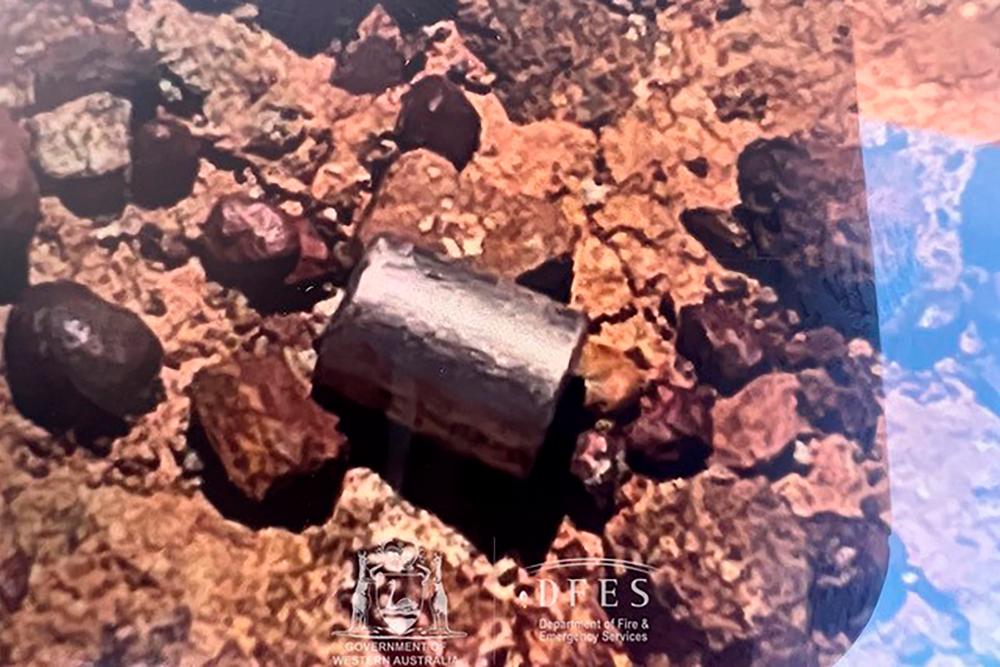 This handout from the Government of Western Australia’s Department of Fire and Emergency Services taken and received on February 1, 2023 shows a radioactive capsule, which had fallen off a truck, after it was found along a desert highway south of Newman, Western Australia. AFPPIX