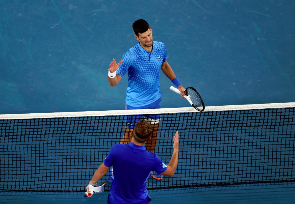 Australian Open, Serbia's Novak Djokovic shakes hands with France's Enzo Couacaud after his second round match/ REUTERSPIX
