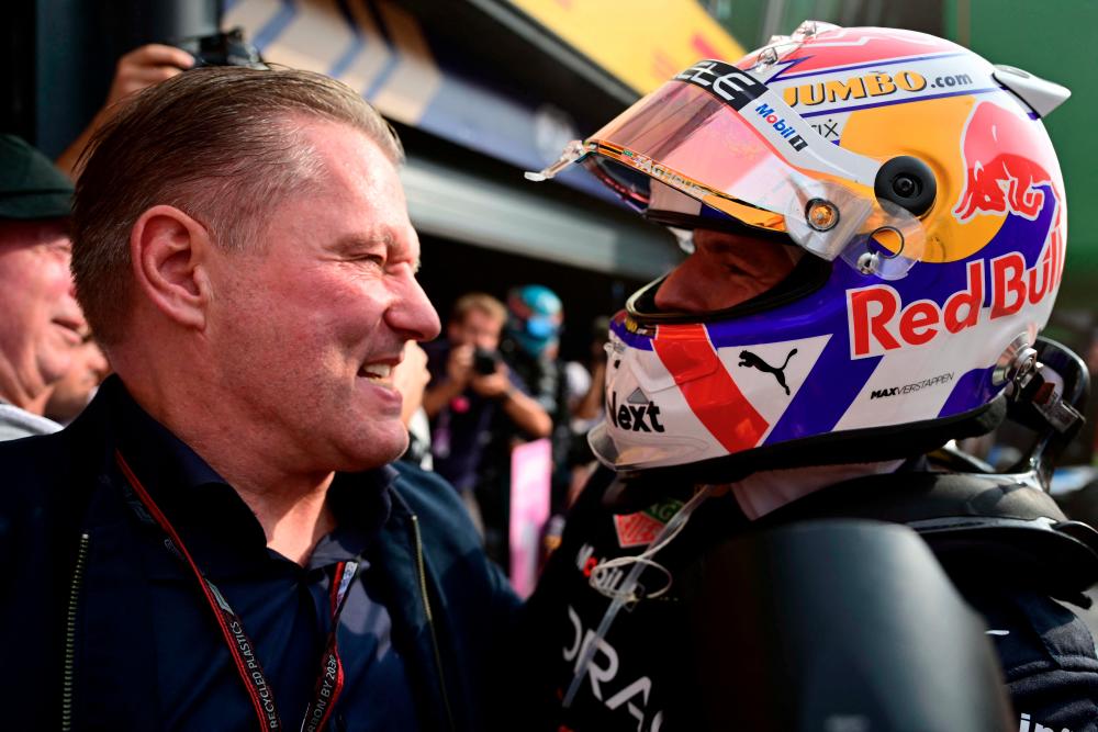 Red Bull Racing's Dutch driver Max Verstappen celebrates with his father Jos Verstappen after winning the Dutch Formula One Grand Prix at the Zandvoort circuit on September 4, 2022. AFPPIX