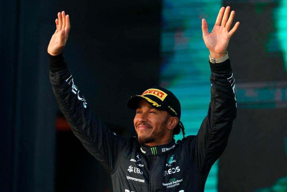 Second-placed Mercedes’ British driver Lewis Hamilton celebrates on the podium after the 2023 Formula One Australian Grand Prix at the Albert Park Circuit in Melbourne on April 2, 2023. AFPPIX