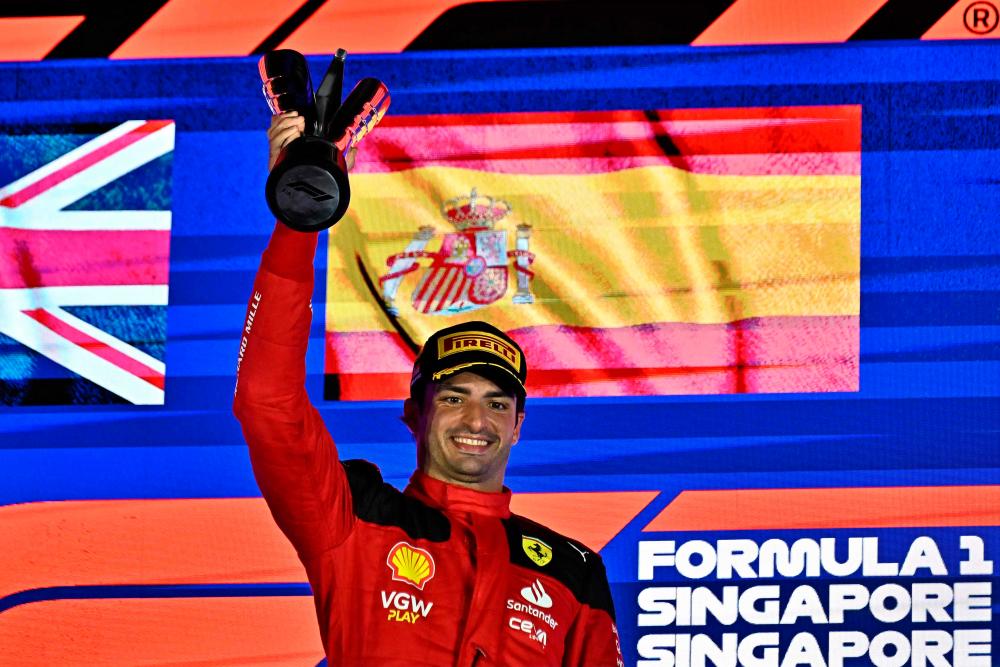 Ferrari's Spanish driver Carlos Sainz Jr celebrates on the podium after winning the Singapore Formula One Grand Prix night race at the Marina Bay Street Circuit in Singapore on September 17, 2023. AFPPIX