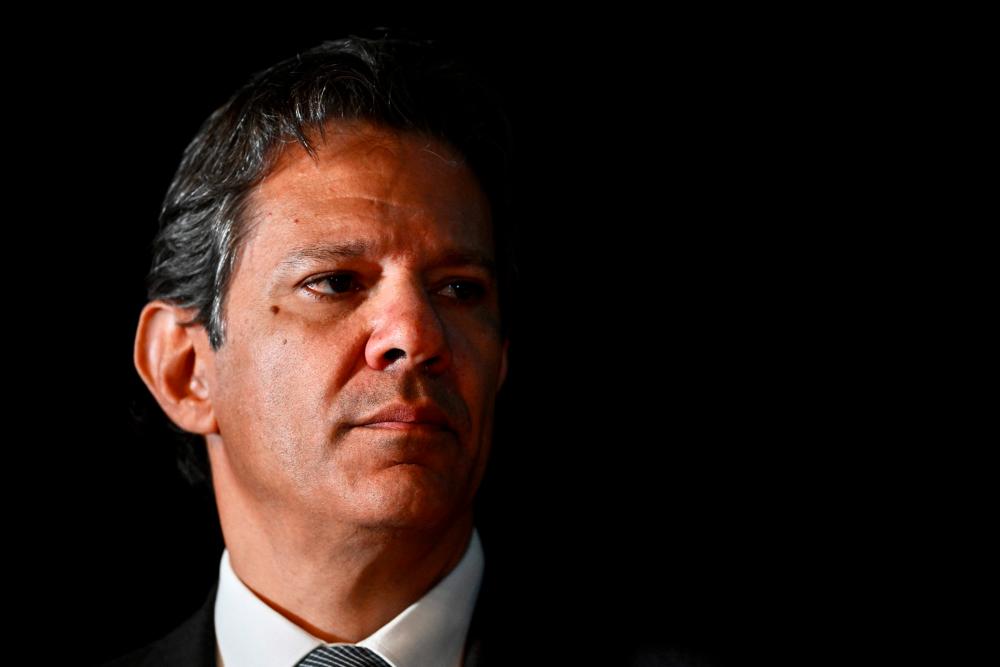Brazilian future Economy Minister Fernando Haddad gestures during a press conference at the transitional government building in Brasilia, on December 9, 2022/AFPPix