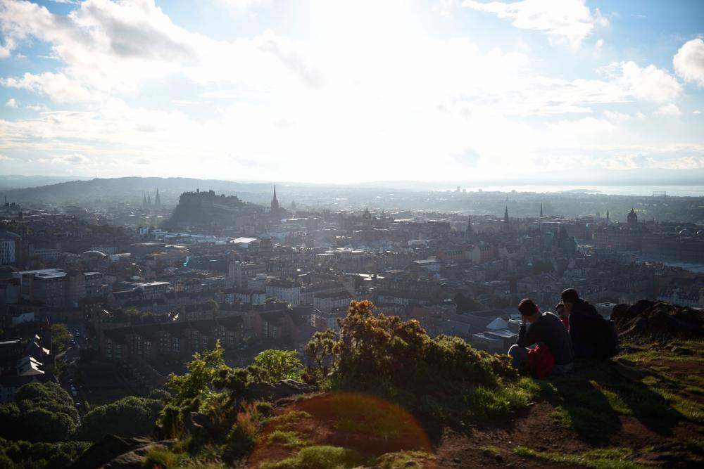 The view of Edinburgh city centre is pictured at sunset from Salisbury Crags in Holyrood Park, Edinburgh, Scotland on June 25, 2016. - AFPPIX