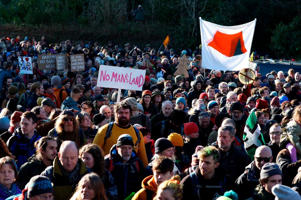‘Right to Roam’ protesters hold placards and flags as they gather in the village of Cornwood on the edge of Dartmoor in south-west England on January 21, 2023, to demonstrate against the recent decision of the UK courts in banning wild-camping from Dartmoor. AFPPIX