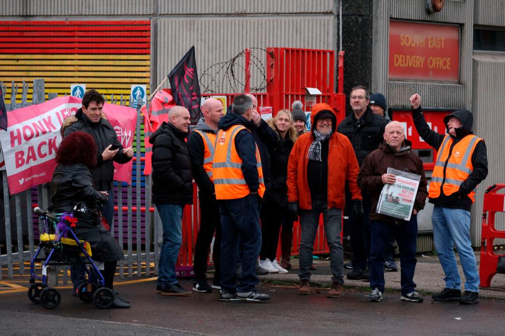 Postal workers stand on a picket line during a strike outside a sorting office in Liverpool, Britain, November 24, 2022. REUTERSPIX