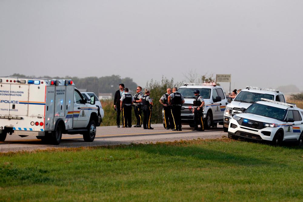 Royal Canadian Mounted Police are seen at the scene where suspect Myles Sanderson was arrested, along Highway 11 in Weldon, Saskatchewan, Canada/AFPPix