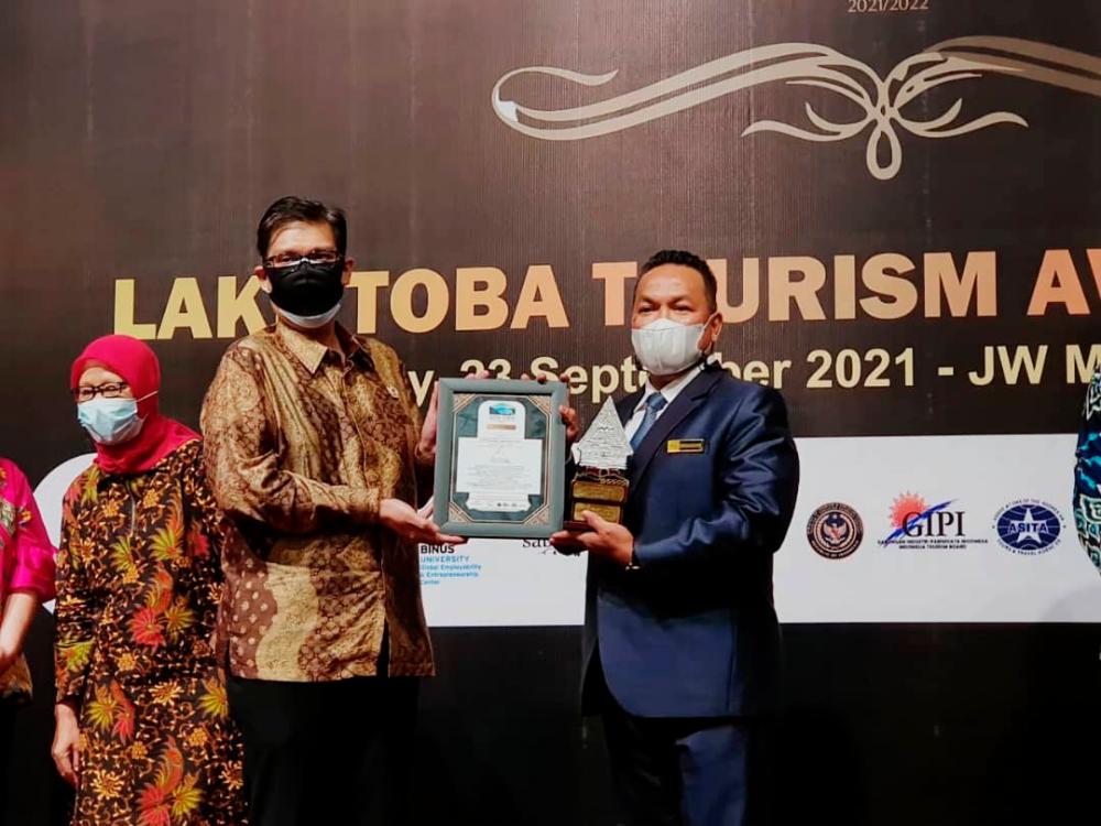 President of Indonesian Travel &amp; Tourism Awards (ITTA) Foundation, Panca R. Sarungu (left) hands over plaque and trophy award to the Director of Tourism Malaysia Medan, Hishamuddin Mustafa (right) during the Lake Toba Tourism Awards 2021, which took place at JW Marriot Hotel Medan, Indonesia recently. -Tourism Malaysia website