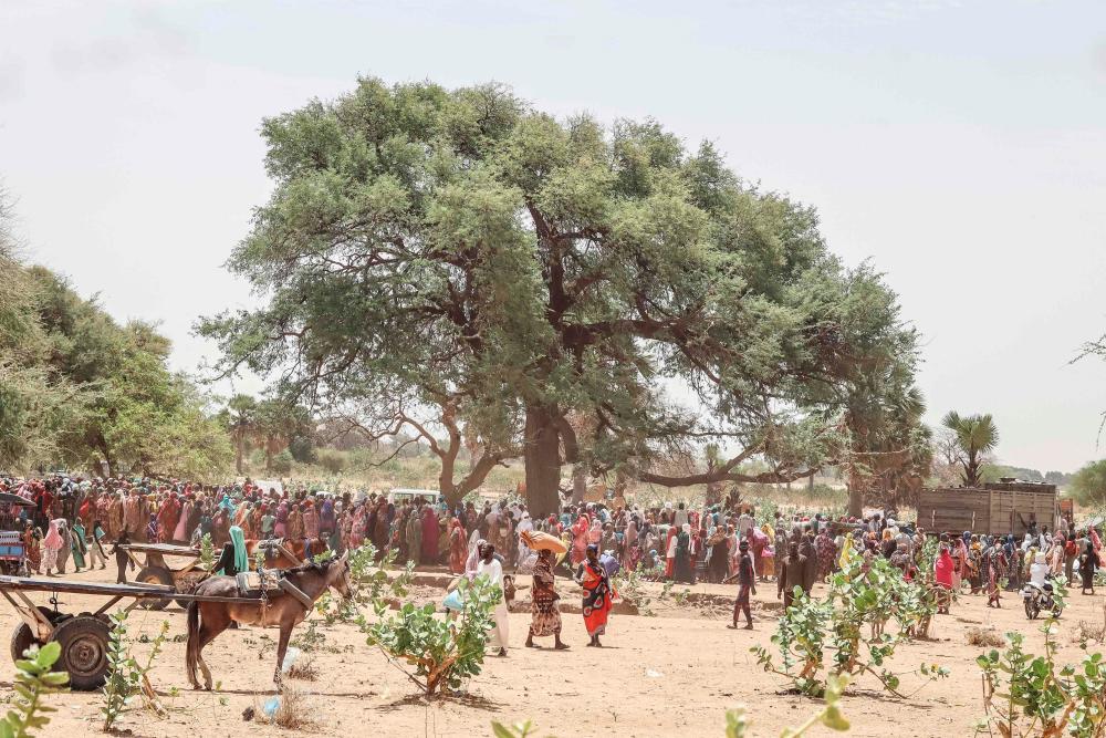 Sudanese refugees from the Tandelti area who crossed into Chad, in Koufroun, near Echbara, gather on April 30, 2023 for an aid distribution. AFPPIX