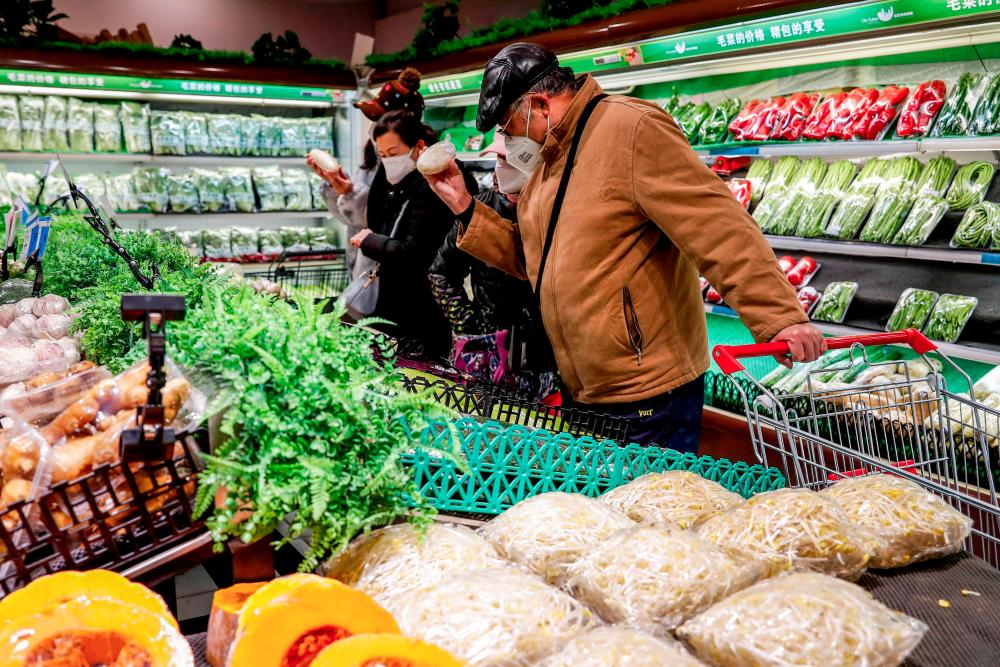 This photo taken on December 5, 2022 shows people shopping at a supermarket in Urumqi, in China's northwestern Xinjiang region, following the easing of Covid-19 restrictions in the city. - AFPPIX