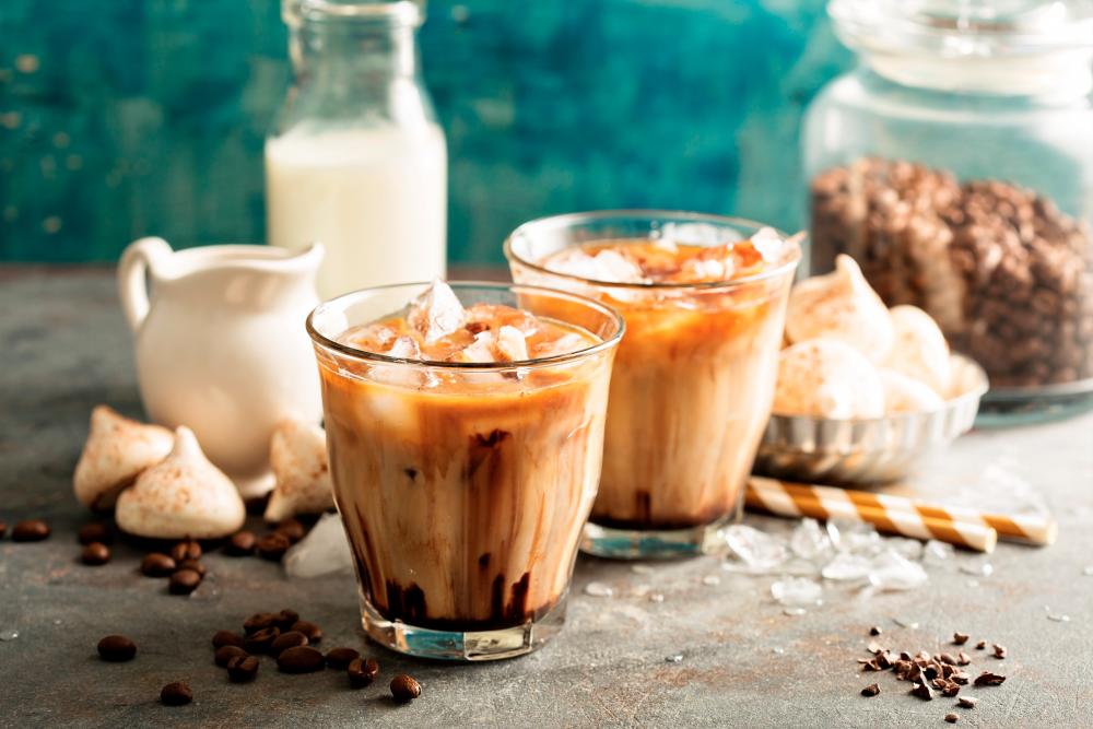 Iced coffee is prepared from brewed hot coffee and serving it over ice. – 123RF