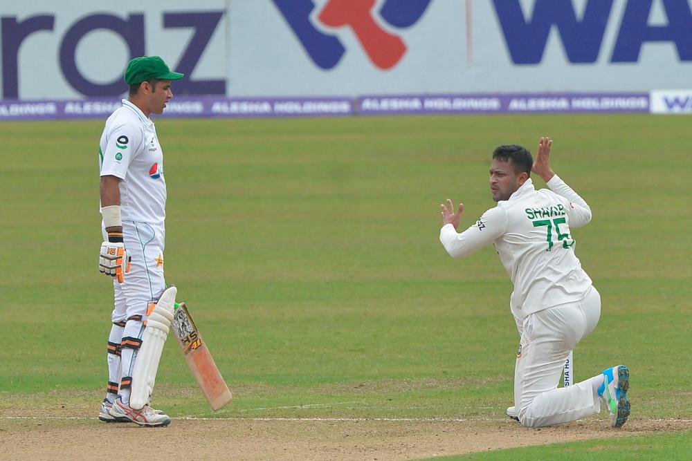 Bangladesh's Shakib Al Hasan (R) appeals unsuccessfully for the LBW (leg before wicket) against Pakistan's Abid Ali on the first day of the second Test cricket match between Bangladesh and Pakistan at the Sher-e-Bangla National Cricket Stadium in Dhaka on December 4, 2021. AFPpix