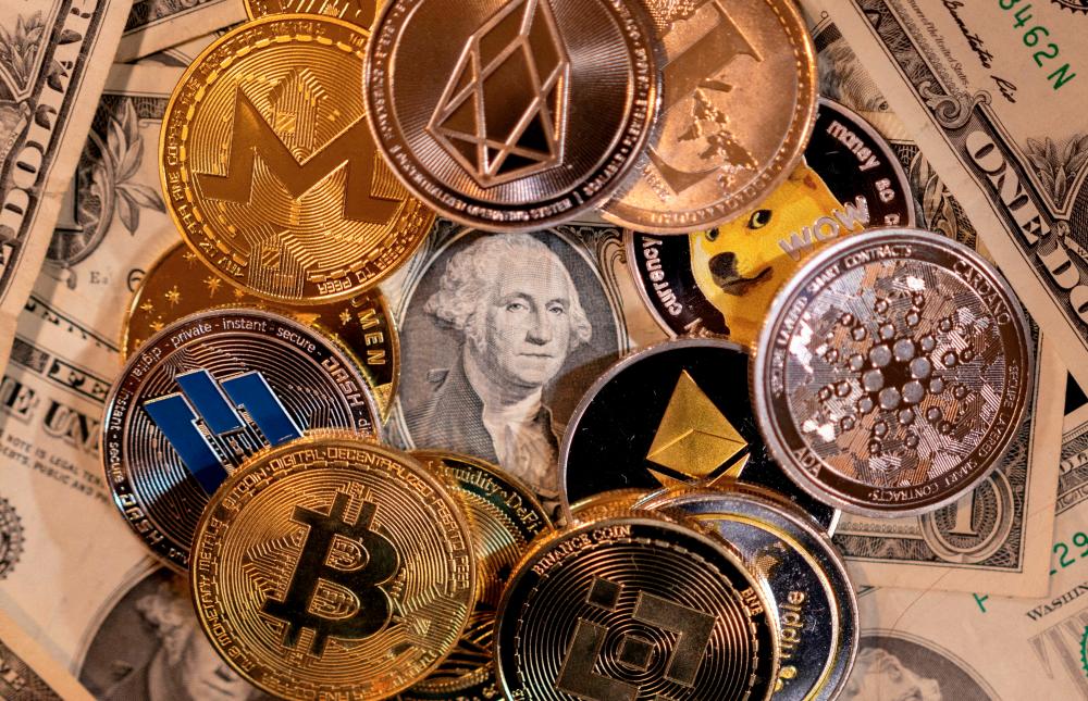 Representations of virtual cryptocurrencies on US dollar banknotes are seen in this illustration. – Reuterspic
