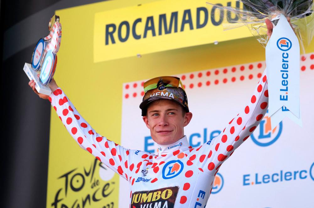 Jumbo-Visma team's Danish rider Jonas Vingegaard celebrates with the climber's dotted jersey on the podium after the 20th stage of the 109th edition of the Tour de France cycling race, 40,7 km individual time trial between Lacapelle-Marival and Rocamadour, in southwestern France, on July 23, 2022. AFPPIX