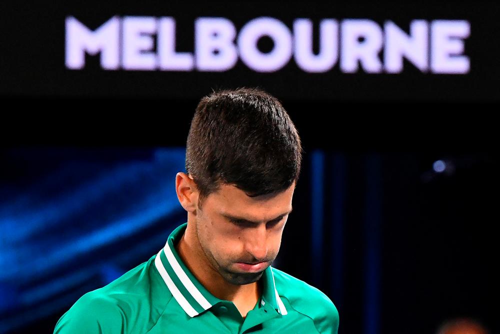 (FILES) This file photo taken on February 12, 2021 shows Serbia's Novak Djokovic reacting while playing against Taylor Fritz of the US during their men's singles match on day five of the Australian Open tennis tournament in Melbourne. AFPpix