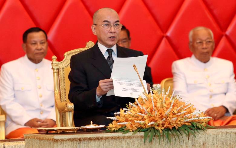 FILE PHOTO: Cambodia’s King Norodom Sihamoni (C) reads a document as he attends a senate meeting in Phnom Penh, Cambodia, April 23, 2018. REUTERSPIX