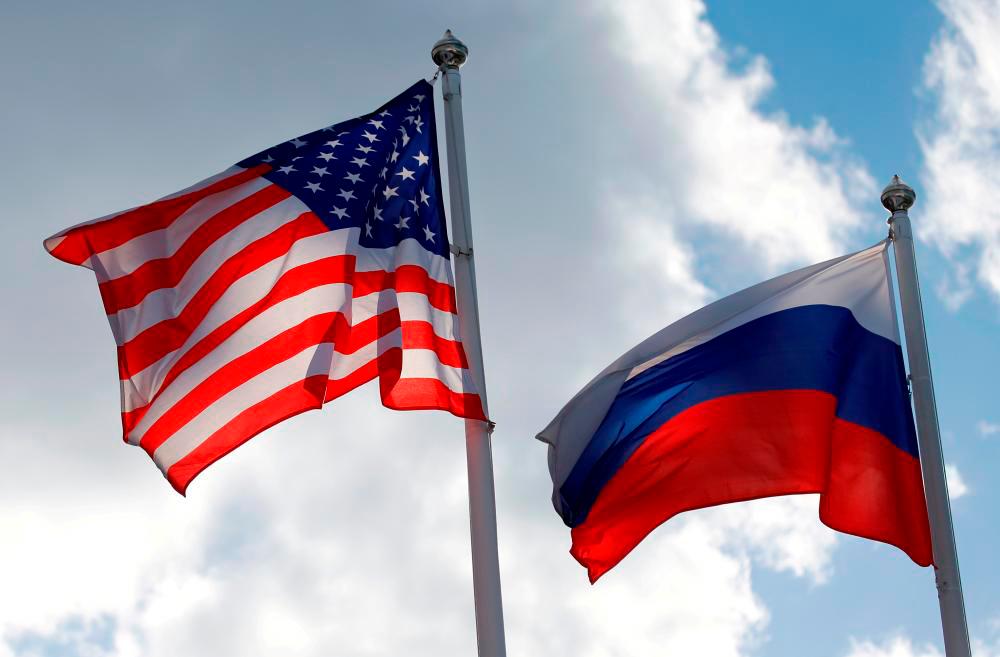 FILE PHOTO: Russian and U.S. state flags fly near a factory in Vsevolozhsk, Leningrad Region, Russia March 27, 2019. REUTERSPIX